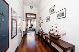 a room with two tables and a model ship on the wall at Fremantle Harbourside Luxury Apartments in Fremantle