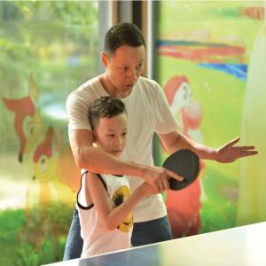 a man and a young boy playing with a paddle at FLC Luxury Resort Vinh Phuc in Hoằng Xá +75 photos