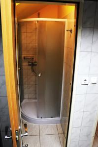 a shower with a glass door in a bathroom at TEJ HOSTEL in Ljubljana