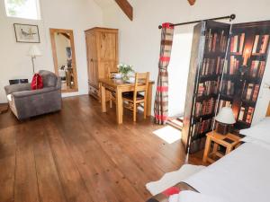 a living room with a desk and a chair and a table at The Old Stable in Haverfordwest