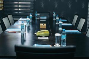 a long table with bottles of water and a telephone at The Amariah Hotel & Apartments Mikocheni in Dar es Salaam