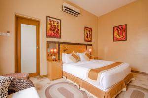 a bedroom with a large bed in a room at The Amariah Hotel & Apartments Mikocheni in Dar es Salaam