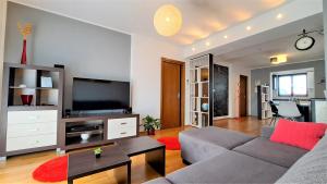 ein Wohnzimmer mit einem Sofa und einem TV in der Unterkunft Urban Premium Apartments in Poreč