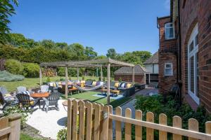 a backyard with a table and chairs and a wooden fence at Winterstoke View-Family&Dog Friendly Beach Retreat in Ramsgate