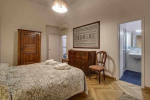 a bedroom with a bed and a bathroom with a sink at Piazza Mentana Apartment in Florence