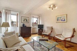 a living room with a couch and chairs and a table at Solaris Apartment With Two Bedrooms in Florence