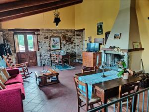 a living room with a couch and a fireplace at La Busca Country House in Monte Benedetto