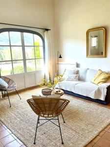 a living room with a bed and a large window at Domaine de la Bastidonne in Céreste