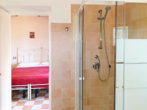 a bathroom with a shower and a bed at Villa Maria Pia in Alghero