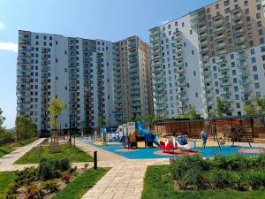 a playground in front of tall apartment buildings at Green Sea Gdańsk in Gdańsk