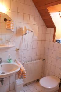 a bathroom with a sink and a toilet at Gasthaus zur Linde in Rothenburg ob der Tauber
