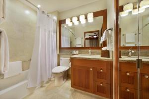 a bathroom with a toilet and a sink and a shower at Napili Kai Beach Resort in Lahaina