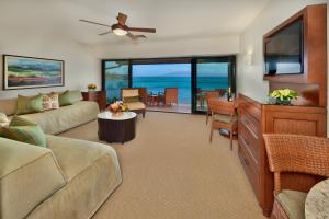 a living room with a couch and a tv at Napili Kai Beach Resort in Lahaina