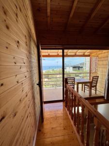 a staircase in a house with a wooden wall at Nashos Bungalows in (( Spile ))