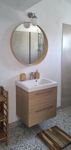 a bathroom with a sink and a mirror at Casa Yasmina in Katastárion