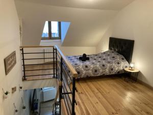 a bedroom with a bed with a cat sitting on it at Appartement au cœur d'Espalion Le Perchoir du Lot in Espalion