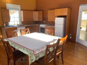 a kitchen with a table and chairs and a refrigerator at Nature Guesthouse Vuthaj in Vusanje