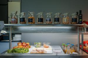 a kitchen with jars of food on a shelf at Hotelli Uninen Loviisa in Loviisa