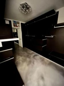 schwarzes Zimmer mit einem Kronleuchter an der Decke in der Unterkunft Villa Anna Onno Lake Como in Onno