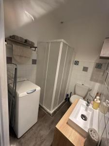 a small bathroom with a toilet and a sink at Charmant studio lumineux Florida plage in Canet-en-Roussillon