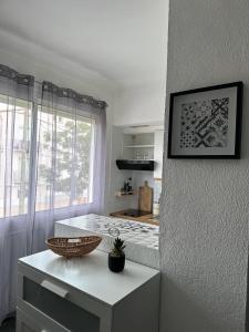 a kitchen with a white counter and a window at Charmant studio lumineux Florida plage in Canet-en-Roussillon