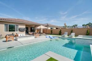 a swimming pool in the backyard of a house at Spectacular PGA West New Home! in La Quinta