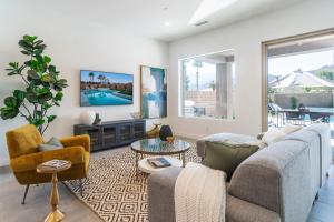 a living room with a couch and chairs and a tv at Spectacular PGA West New Home! in La Quinta