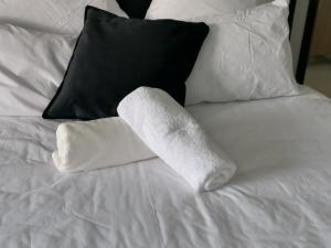 a roll of toilet paper sitting on a bed at Serenity Airb&b Protea Glen in Soweto