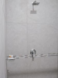 a shower with a glass door with a shower head at Serenity Airb&b Protea Glen in Soweto +36 photos