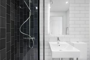 a bathroom with a sink and a shower at Riverside View Apartments in London