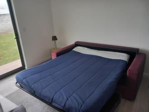 a blue bed in a room with a window at Impeccable 1 Bed Villa in Ribeira Grande in Ribeira Grande