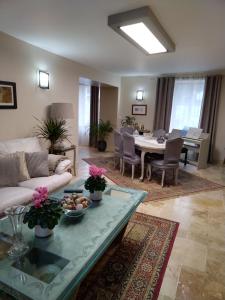 a living room with a couch and a table at Au Fil de l'Eau in Mouroux