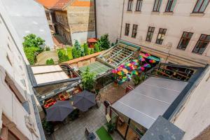an overhead view of a patio with tables and umbrellas at Gozsdu Charming Suite by NeWave Apartments in Budapest