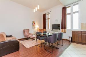 a living room with a table and chairs at Gozsdu Charming Suite by NeWave Apartments in Budapest