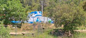 a park with a bench and a water slide at Chez Nat in Rocbaron