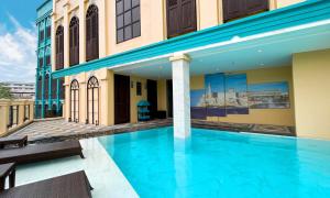 a swimming pool on the roof of a building at The Quba Boutique Hotel Pattaya by Compass Hospitality in Pattaya Central