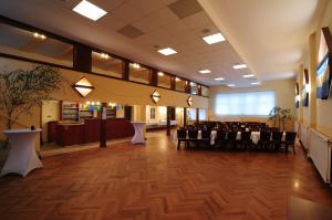 a banquet hall with tables and chairs in a building at Pension Schaumburger-Hof in Fischbeck