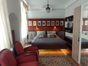 een slaapkamer met een bed en een bank en stoelen bij Parkside Large Modern Garden View Apartment in Boedapest