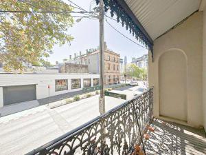 a balcony of a building with a view of a street at Pyrnmont Terrace & Townhouse in Sydney