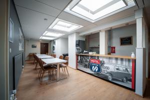 a dining room with a table and a sign on the wall at Motel '69 Lovisa in Loviisa