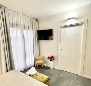a bedroom with a bed and a sliding glass door at Karasole in San Teodoro