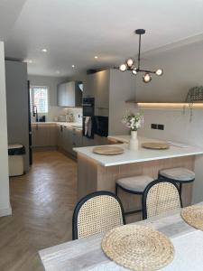 a kitchen with a table and chairs and a counter at Greensfield Close 