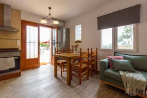 a kitchen and living room with a table and a couch at House with swimming pool and amazing sea and mountain views in Montgó, Denia in Denia