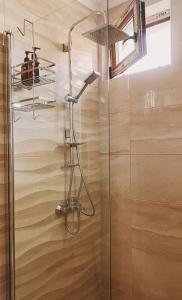 a shower with a glass door in a bathroom at Brand new, luxury beach flat in Tsarevo