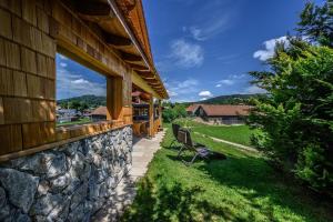 a stone wall next to a house with a window at Wenzlhof in Zwiesel