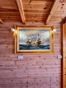 a painting of a battleship hanging on a wall at Nashos Bungalows in (( Spile ))
