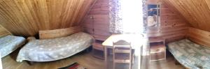 a room with two beds in a wooden cabin at Kivitasku in Kalajoki