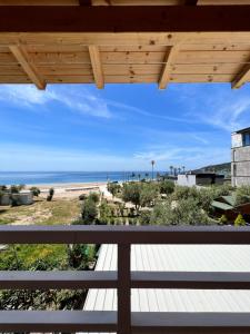 a view of the beach from the balcony of a beach house at Nashos Bungalows in Spile