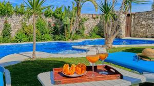 a tray of fruit and wine glasses next to a swimming pool at Apto El Descanso III Conil de la Frontera by Ruralidays in Conil de la Frontera +10 photos