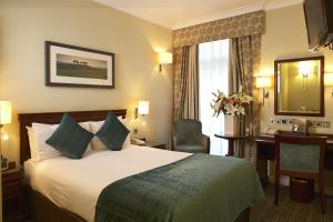 a hotel room with a large bed and a large window at The Rembrandt in London